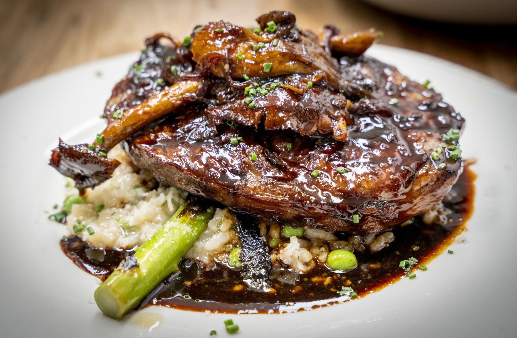 14oz Ribeye with mushroom espagnole and English pea risotto